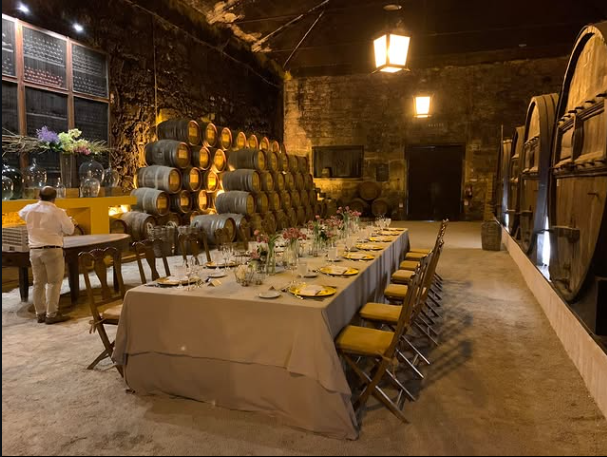 A long table laid for dinner in a barrel cellar